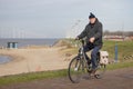 Man with his little son at bycycle near Dutch coast