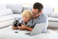 Man and his little son playing with camera Royalty Free Stock Photo