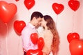 Man with his lovely sweetheart girl kiss at Lover`s valentine day. Valentine Couple. Couple kiss and hug. On background red Royalty Free Stock Photo