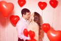 Man with his lovely sweetheart girl kiss at Lover`s valentine day. Valentine Couple. Couple kiss and hug. On background red Royalty Free Stock Photo