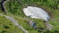 Man on his mountain bike going down the path from Jochpass over Engelberg in the Swiss Alps Royalty Free Stock Photo