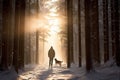 A man and his pet dog walking though a snowy forest on sunny winter day. Adventurous young man and his dog on a walk. Hiking and