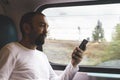 Man on his phone travelling on train Royalty Free Stock Photo