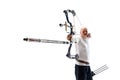 Man in his 40s, archery athlete with bow and arrow aiming at archery target isolated over white studio background Royalty Free Stock Photo