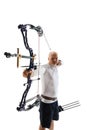 Man in his 40s, archery athlete with bow and arrow aiming at archery target isolated over white studio background Royalty Free Stock Photo