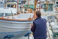 Man in His 50s or 60s Probably Retired Painting a Traditional Majorcan Boat