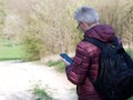 Man in his seventies looking at his smartphone