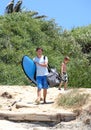 Man and his son arriving at the beach to surf Royalty Free Stock Photo