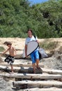 Man and his son arriving at the beach to surf Royalty Free Stock Photo