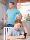 Man with his son are conflicting and boy playing with phone Royalty Free Stock Photo