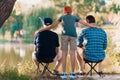 A man, his son and his elderly father are fishing early in the morning on the river bank. Royalty Free Stock Photo