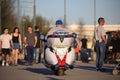 Man on his Victory motorcycle in the pedestrian zone among people on a sunny evening Royalty Free Stock Photo