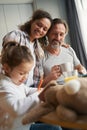 Man with his wife drinking tea and looking at daughter Royalty Free Stock Photo