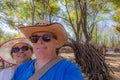 Man with his woman behind smiling against green foliage and blue sky, enjoying in public park Royalty Free Stock Photo