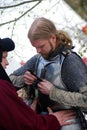 Man in historical costume (a knight) prepares for a battle. Royalty Free Stock Photo