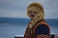 A man in a historical Sami costume on the embankment of Lake Onega. Royalty Free Stock Photo