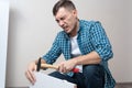 Man hit his thumb with hammer assembling furniture Royalty Free Stock Photo