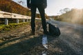 Man hitchhiking on a country road. Royalty Free Stock Photo