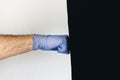Man hits punching bag with medical gloves