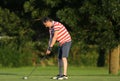 Man hitting driver club in the golf course club in the sunset Royalty Free Stock Photo