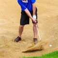 Man hitting golf ball out of a bunker Royalty Free Stock Photo