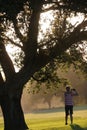 Man hitting iron club in the golf course club in the sunset Royalty Free Stock Photo