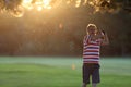 Man hitting iron club in the golf course club in the sunset Royalty Free Stock Photo