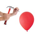 Man hitting a nail into a red balloon Royalty Free Stock Photo