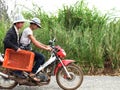 Man hmong tribal people and men thai karen ethnic riding local old motorcycle on street and traffic road on Mon Jam village