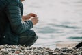 Man hobby fishing on sea tightens a fishing line reel of fish. Calm surface sea. Close-up of a fisherman hands twist Royalty Free Stock Photo