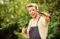 Man hold barbeque equipment. Grilling food. Barbecue utensils. Summer weekend. Tools for roasting meat outdoors Royalty Free Stock Photo