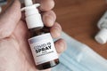 Man hold a bottle of covid-19 spray made with monoclonal antibodies