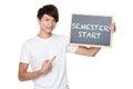 Man hold with chalkboard showing phrase of semester start Royalty Free Stock Photo