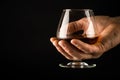 Man hold Cognac or brandy glass in his hand. Royalty Free Stock Photo