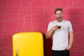 Man hold cup of tea or coffee in kitchen. Sleepy macho yawn at retro fridge. Bachelor with morning drink at refrigerator. Breakfas Royalty Free Stock Photo