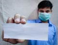 Man hold Empty slip in stretch hand wear face mask Royalty Free Stock Photo