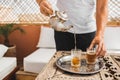 Man hold in hand silver vintage teapot and pouring traditional mint moroccan tea Royalty Free Stock Photo