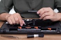 A man hold hard disk with screwdriver in hand repair laptop computer upgrade Royalty Free Stock Photo