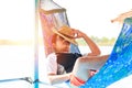 A man hold hat and sleep on hammock near the river. Royalty Free Stock Photo