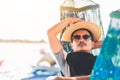 A man hold hat and sleep on hammock near the river Royalty Free Stock Photo