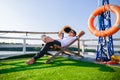 A man hold hat and  wear sunglasses. He lie on sunbeds in the cruise ship Royalty Free Stock Photo