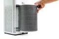Man hold a old Filter of the air purifier check with change filter in side air purifier for dust removal efficiency on white