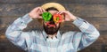 Man hold pepper harvest as funny grimace. Chilli and sweet pepper as smile and eyes. Bearded farmer hold peppers in