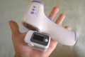 Man hold pulse oximeter and digital fever thermometer,oxygen saturation in covid19 pandemic,medical home treatment