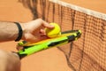 Man hold racket tennis ball against clay court Royalty Free Stock Photo