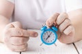 Man hold and shocked with late alarm clock