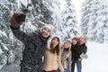 Man Hold Smart Phone Camera Taking Selfie Photo Friends Smile Snow Forest Young People Group Outdoor Royalty Free Stock Photo