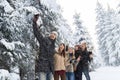 Man Hold Smart Phone Camera Taking Selfie Photo Friends Smile Snow Forest Young People Group Outdoor Royalty Free Stock Photo