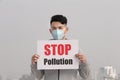 Man hold stop pollution sign