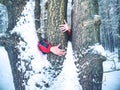 Man hold tree trunk with the frozen bark covered with sticky snow